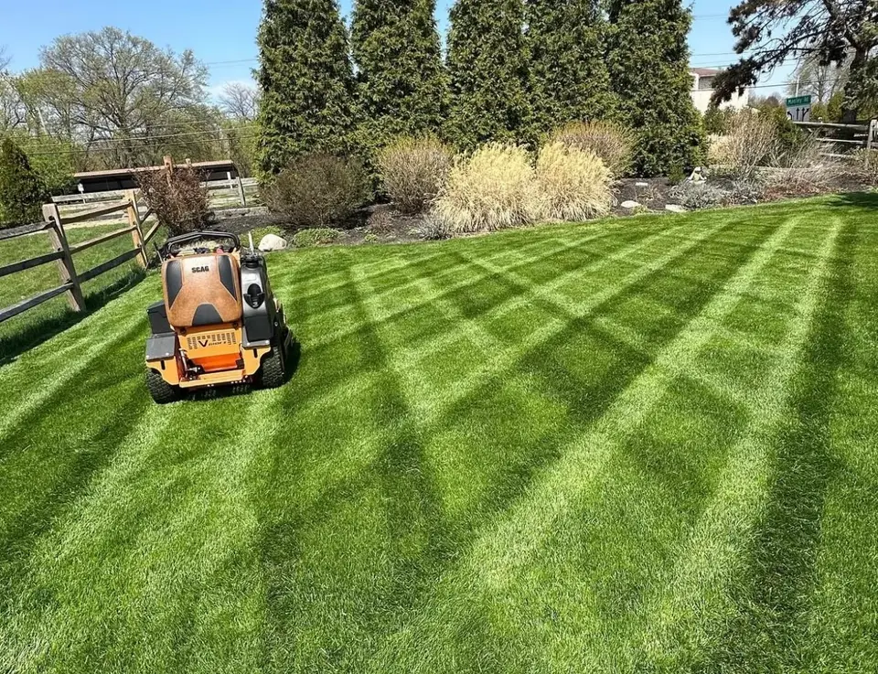 Striped lawn being mowed on a zero-turn mower